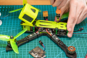 man-repairing-a-broken-drone - drone camera - gimbal system - newtodrones