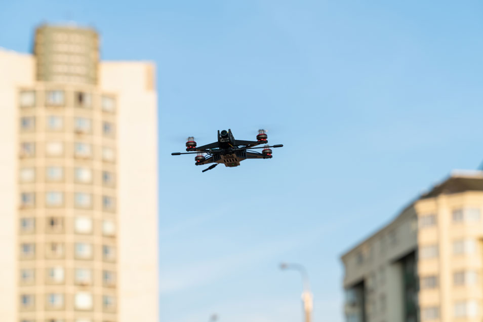 ai powered drones - drone flying through city - new to drones