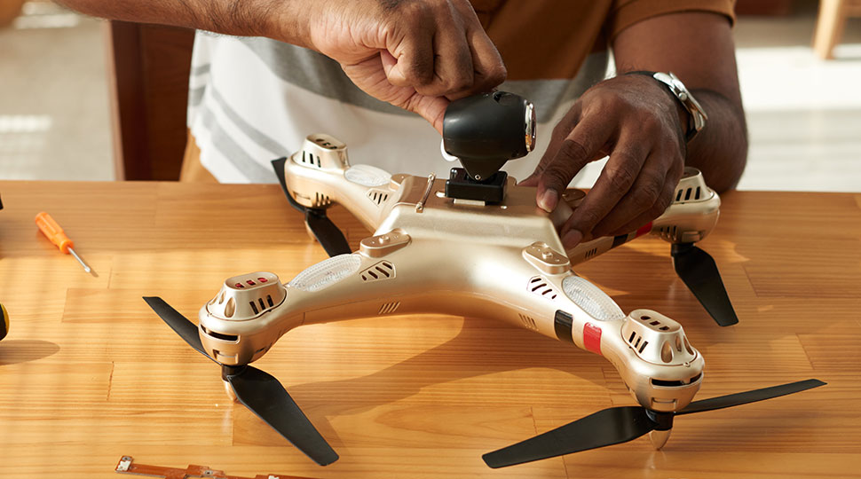 drone maintenance - man repairing a drone - new to drones