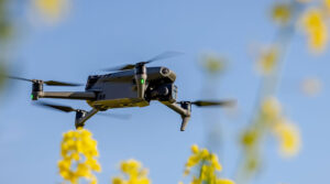 drone noise emission regulations - drone flying in front of flowers - newtodrones