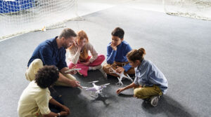 drone training certification - group of young people learning to fly drone - new to drones